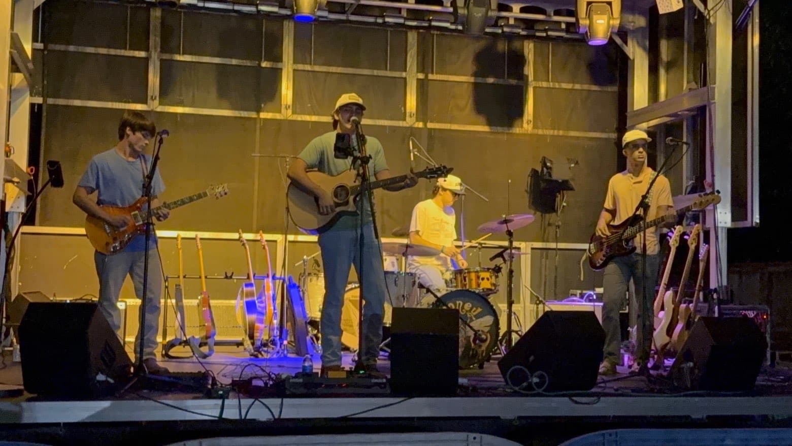 Greyhound on stage under colored lights